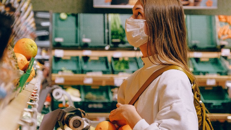Woman in mask at a grocery store